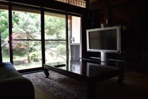 a living room with a flat screen tv on a table at Guest House Miei - Vacation STAY 87536v in Nagahama