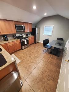 a large kitchen with a table and a refrigerator at Boston's Best Vacation House in Boston