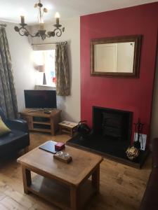 a living room with a couch and a fireplace at Hope Terrace in Matlock