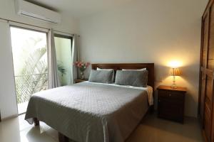 a bedroom with a bed and a large window at Hotel Suites Del Mar in La Manzanilla