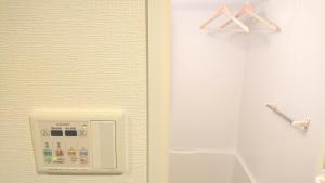 a bathroom with a soap dispenser on a wall at Carsail Sole - Vacation STAY 13224 in Saitama