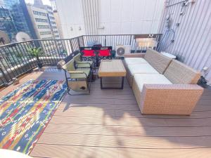 a balcony with a couch and tables and a rug at commun ryogoku - Vacation STAY 97137v in Tokyo