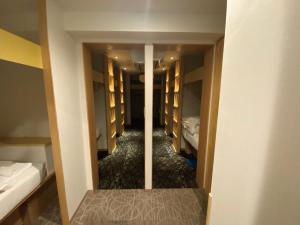 a corridor of a hotel room with beds and a hallway at commun ryogoku - Vacation STAY 96357v in Tokyo