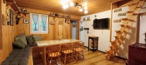 a living room with a bar and a tv at Koča Kresnica in Ilirska Bistrica