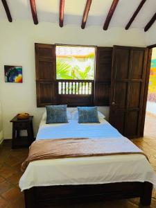 Tempat tidur dalam kamar di Hostal Sueño Real Campestre
