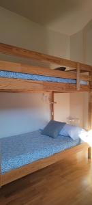 a bedroom with two bunk beds with a blue bed at Los Cachorros in El Pueyo de Jaca +38 photos