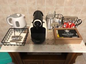 a counter with a coffee maker and other items on it at Le Terrazze Rooms in Ferrara