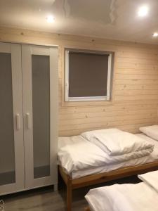 a bedroom with two beds and a window at Słoneczne ranczo Zator Energylandia in Zator