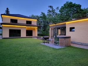 a house with a large yard in front of it at Vomikay Villa in Tallinn