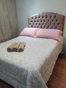 a bed with two blankets and two towels on it at Quarto Inteiro Privado - 3km Oktoberfest in Blumenau