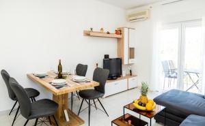 un soggiorno con tavolo, sedie e divano di Apartment Marin a Milna