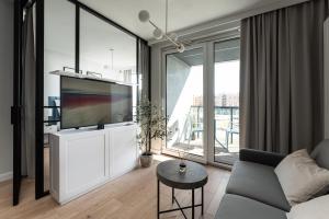 a living room with a large flat screen tv at Apartament Chlebova 315 in Gdańsk