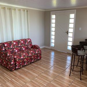 a living room with a couch and a table at Sítio AnJo’Z in Rio Negro