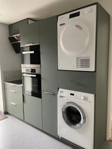 a kitchen with a washing machine and a washer at Nice apartment in the middel of Tórshavn in Tórshavn