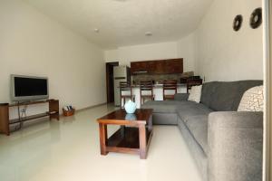 a living room with a couch and a table at Hotel Suites Del Mar in La Manzanilla