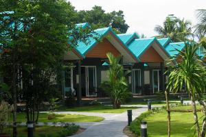 a resort with blue roofs and palm trees at Hongte Khaolak Resort in Khao Lak