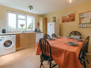 a kitchen and dining room with a table and chairs at Eudon Burnell Cottage in Eardington