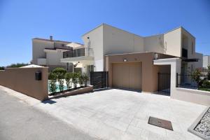 a large white house with a large driveway at Villa Abyss in Zadar
