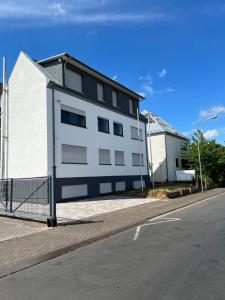 a white building on the side of a street at Olymp Wettenberg - Monteurzimmer in Launsbach