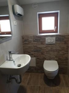 a bathroom with a sink and a toilet and a window at GuestHouse Flora in Koper +4 photos