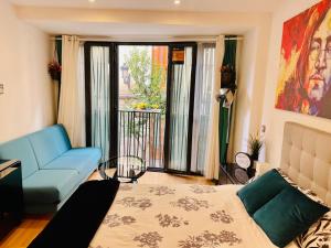 a room with a bed and a couch and a window at MADRID CENTRO - CALLAO - GRAN VIA - MUY CENTRICO in Madrid +15 photos