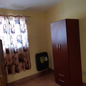 a room with a cabinet and a window at ALVY in Victoria +1 photo