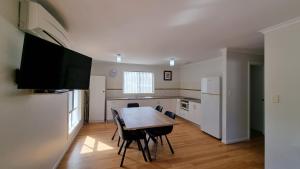a kitchen and dining room with a table and chairs at Wallaroo Holiday Park in Wallaroo