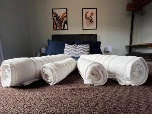 a bed with rolled towels on top of it at Paz na Montanha in Campos do Jordão
