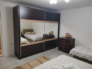 a large mirror in a bedroom with a bed at Vila Ivana in Krajišnići