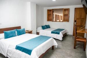 Postel nebo postele na pokoji v ubytování Hotel Santa Laura