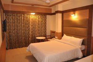 Cama ou camas em um quarto em Hotel SMS Grand Inn