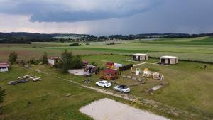 an aerial view of a farm with a car parked in a field at Domki Polana in Piotrkowiczki +6 photos