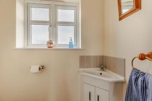 a bathroom with a sink and a window at Wood Cottage in Tenbury +40 photos