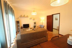 a living room with a couch and a television at Retorta do Pico - Alojamento Local in Caminha