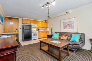 a living room with a couch and a table at The Bamboo Oasis at Bamboo Waikiki #307 in Honolulu