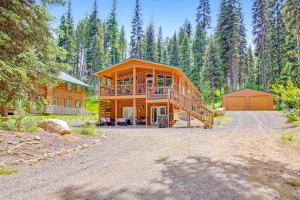 a large wooden house in the middle of a forest at Cabin in the Cove in McCall