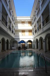 an indoor pool in a building with an umbrella at Boracay Sands Hotel in Boracay