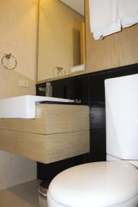 a bathroom with a toilet and a sink at Boracay Sands Hotel in Boracay