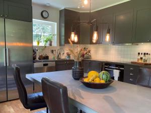 a kitchen with a table with a bowl of fruit on it at 5 person holiday home in KLÖVEDAL-By Traum in Klövedal
