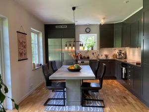 a kitchen with a table with a bowl of fruit on it at 5 person holiday home in KLÖVEDAL-By Traum in Klövedal +33 photos