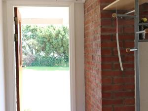 a brick wall next to a door with a window at 5 person holiday home in TRÄSLÖVSLÄGE-By Traum in TrÃ¤slÃ¶vslÃ¤ge +21 photos