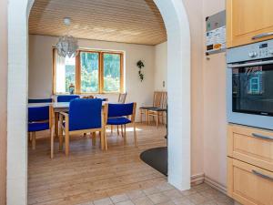 a kitchen and dining room with a table and chairs at 10 person holiday home in Ulfborg-By Traum in Ulfborg