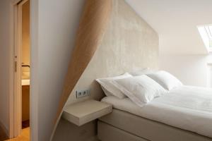 a bedroom with a bed with a triangular headboard at Hotel Boutique Berazadi Berri in Zarautz
