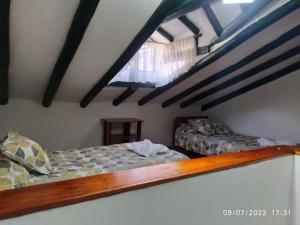 a bedroom with two beds in a attic at CASA VILLA LUGUIANGA Villa de Leyva in Villa de Leyva