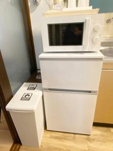 a microwave oven sitting on top of two white boxes at ラ・ポート空港前107 in Shime