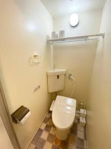 a bathroom with a white toilet in a stall at ラ・ポート空港前107 in Shime +10 photos