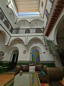 a living room with a couch and a glass table at Riad Assalam in Marrakech