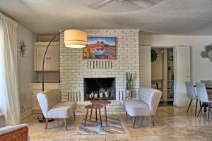 a living room with a fireplace with chairs and a table at VIEWS! Uptown Sedona Utopia +Hot Tub in Sedona