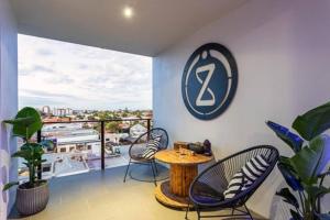 a room with a table and chairs on a balcony at Inner city 1 bedroom Apartment with Rooftop pool and Parking - Serain Residences in Brisbane