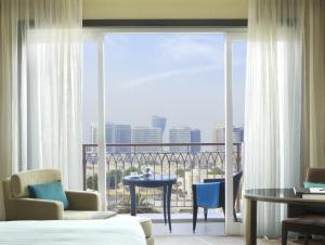 a hotel room with a view of the city at Anantara Eastern Mangroves Abu Dhabi in Abu Dhabi